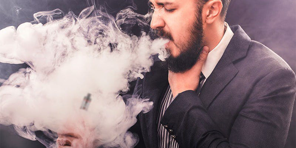 Person coughing burnt vape, bad vape taste, spitting vape, rooftop lounge Dubai night, unpleasant vaping experience - Why Does My Vape Taste Burnt (Causes, Fixes & Prevention Tips)