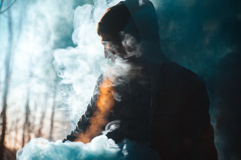 a man sitting in a vape cloud for does vape juice expire
