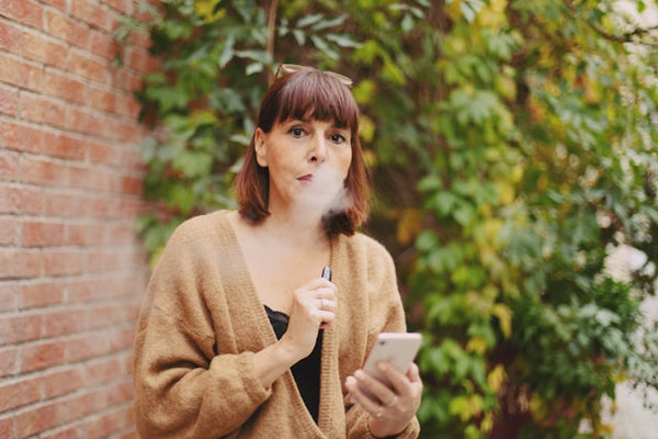 a middle-aged woman with a vape pen
