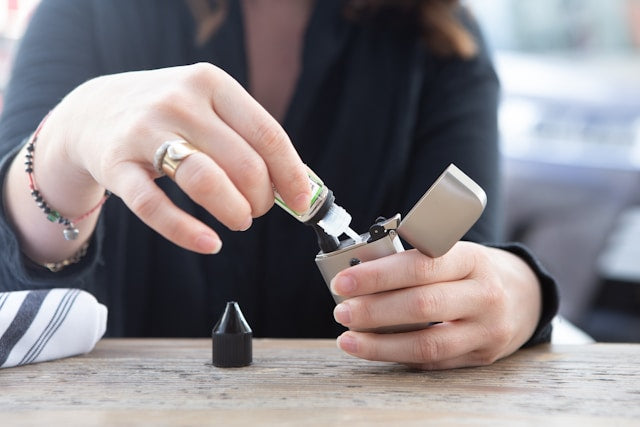 a woman refilling a vaping device for does vape juice expire
