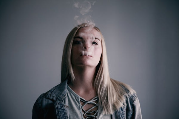 a woman vaping for how much nicotine is in a elf bar
