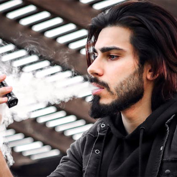 a person vaping outdoors for how to vape
