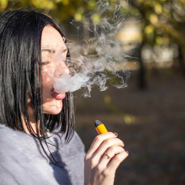 Young Woman Vaping Disposable